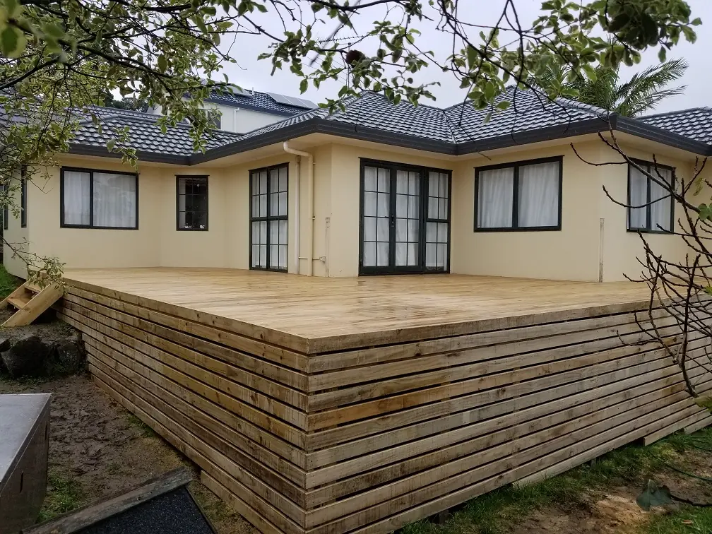 A completed timber deck wrapping around a West Auckland home