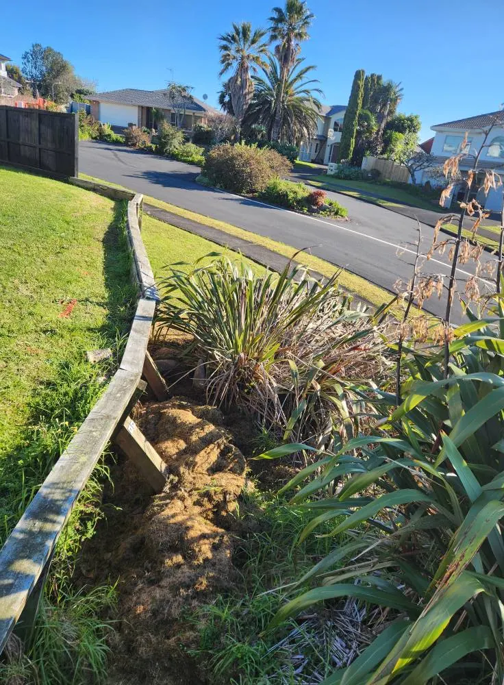 Before: Timber retaining wall renewal and drainage in Massey